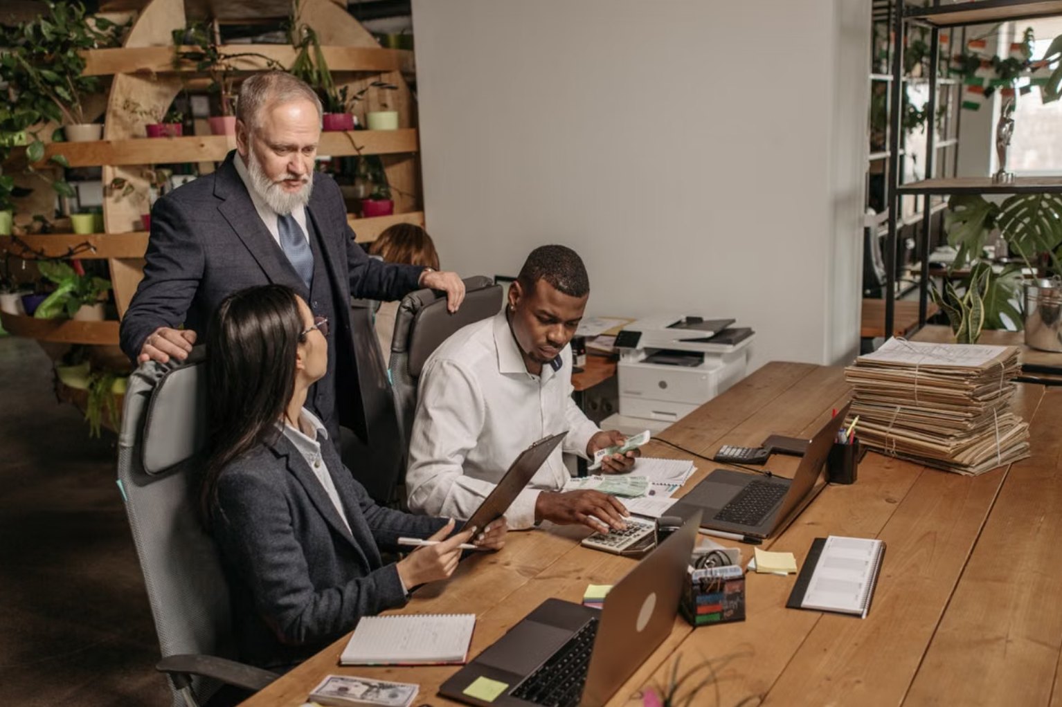 Colleagues reviewing accounts together at a shared desk