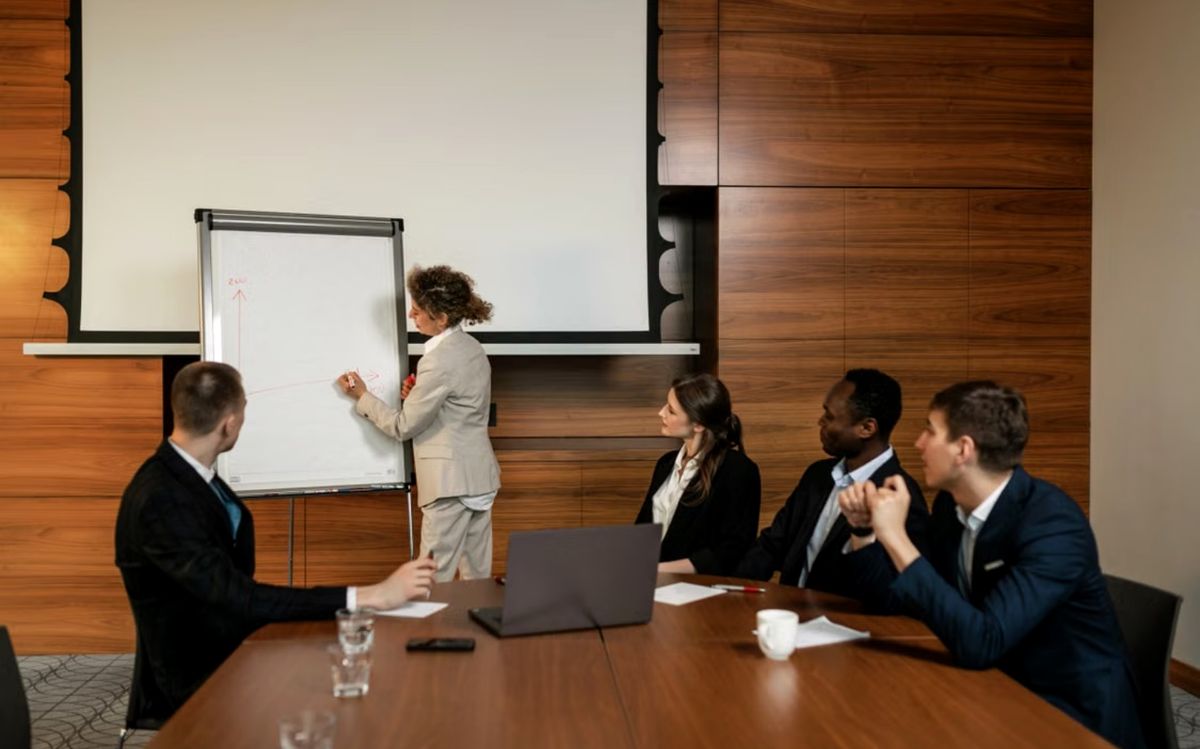 Adviser presenting to a leadership team in a boardroom